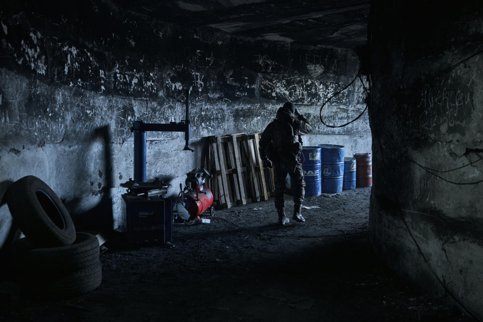 A Ukrainian soldier walks in an underground command center in Bakhmut, Donetsk region, Ukraine, Sunday, Dec. 25, 2022. (AP Photo/Libkos)