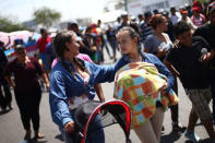 A Central American migrant, moving in a caravan through Mexico, holds a baby as she takes part in a demonstration against the U.S President Donald Trump's immigration policies, in Hermosillo, Sonora state, Mexico April 23, 2018. REUTERS/Edgard Garrido