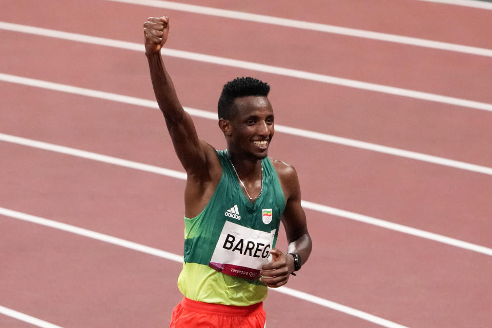 Selemon Barega, of Ethiopia, celebrates after winning the men's 10,000-meter run at the 2020 Summer Olympics, Friday, July 30, 2021, in Tokyo. (AP Photo/Charlie Riedel)