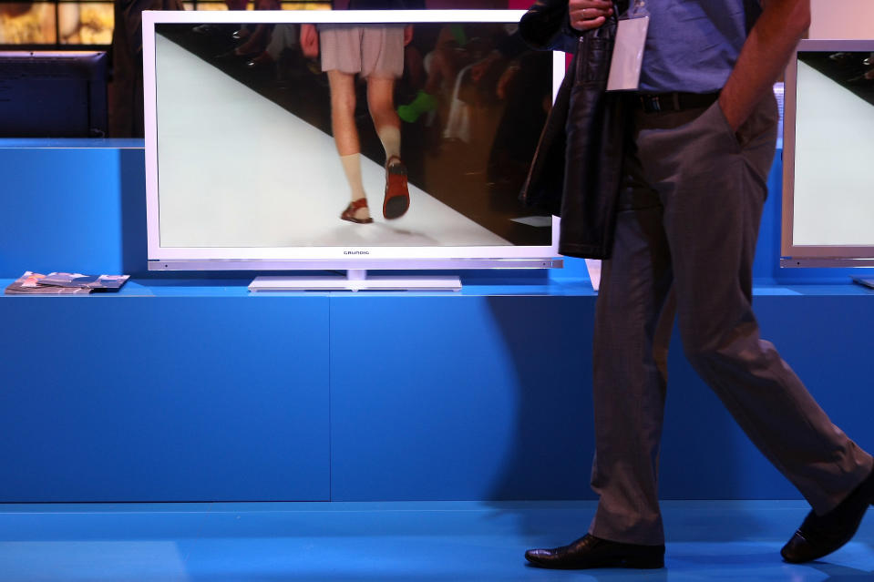 BERLIN, GERMANY - AUGUST 31: A visitor passes a Grundig 46 VLE 8160 WL television screening a men's fashion show at the Grundig stand during the Internationale Funkausstellung (IFA) 2012 consumer electronics trade fair on August 31, 2012 in Berlin, Germany. Microsoft, Samsung, Sony, Panasonic and Philips are amongst many of the brands showcasing their latest consumer electronics hardware, software and gadgets to members of the public from August 31 to September 5. (Photo by Adam Berry/Getty Images)