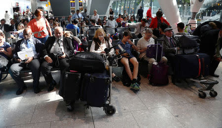 People wait with their luggage at Heathrow Terminal 5 in London, Britain May 27, 2017. REUTERS/Neil Hall