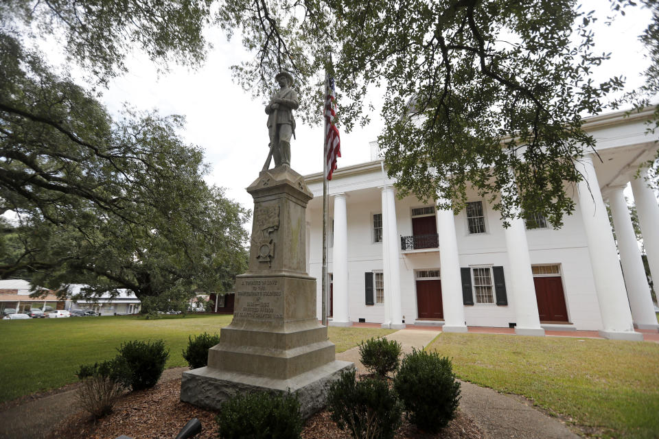 In this Aug. 1, 2018 file photo, a statue commemorating fallen confederate soldiers stands on front of the East Feliciana Parish Courthouse in Clinton, La. As protests sparked by the death of George Floyd in Minneapolis focus attention on the hundreds of Confederate statues still standing across the Southern landscape, officials in the rural parish of roughly 20,000 people recently voted to leave the statue where it is. (AP Photo/Gerald Herbert, File)