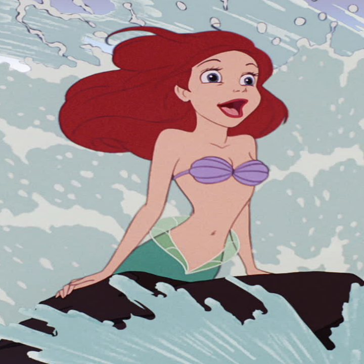 Ariel with the waves crashing on her