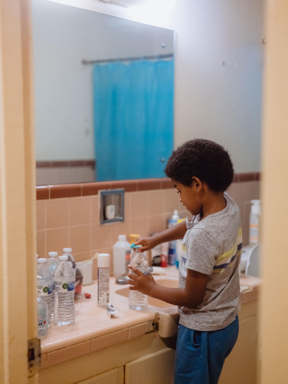 Langston Floyd, 6, uses bottled water to brush his teeth on Sep. 5, 2022 in Jackson. The day to day challenges of having to use bottled or boiled water for almost every aspect of their life is not a new concept for the Floyd family. For the majority of Langston's life there have been multiple boil water notices for the city of Jackson every year.<span class="copyright">Christopher Lee for TIME</span>