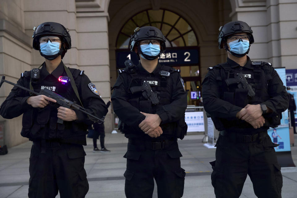 Police officers wearing face masks to protect against the spread of new coronavirus stand guard outside of Hankou train station ahead of the resumption of train services in Wuhan in central China's Hubei Province, Wednesday, April 8, 2020. After 11 weeks of lockdown, the first train departed Wednesday morning from a re-opened Wuhan, the origin point for the coronavirus pandemic, as residents once again were allowed to travel in and out of the sprawling central Chinese city. (AP Photo/Ng Han Guan)