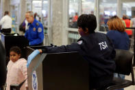 Transportation Security Administration (TSA) agents screen passengers at a security checkpoint at Hartsfield-Jackson Atlanta International Airport amid the partial federal government shutdown, in Atlanta, Georgia, U.S., January 18, 2019. REUTERS/Elijah Nouvelage