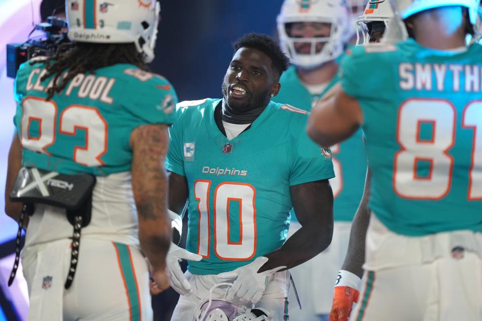 Miami Dolphins wide receiver Tyreek Hill (10) prepares to enter the field for warm-ups before the start of a NFL football game against the Tennessee Titans at Hard Rock Stadium in Miami Gardens, Dec. 11, 2023.