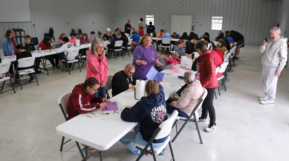 A group makes get well cards at Camp Benedictine, which was having its spring camp for individuals with special needs this month at its new facility in McLoud.