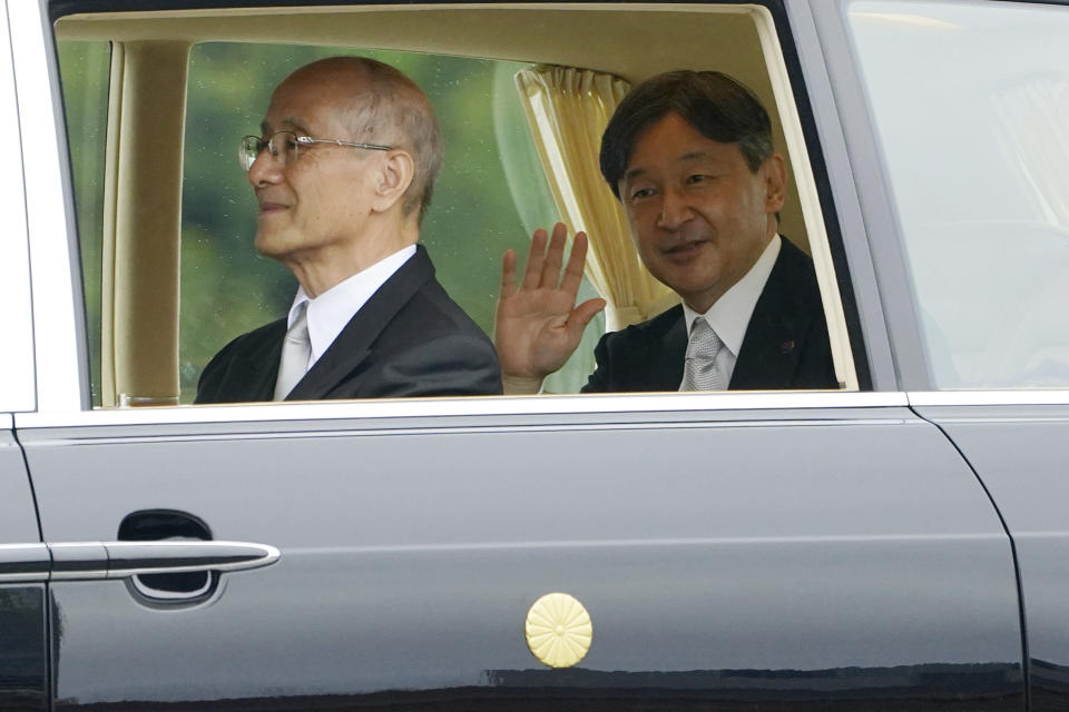 Emperor Naruhito waves as he leaves the Imperial Palace after the enthronement ceremony, Tuesday, Oct. 22, 2019, in Tokyo, Japan. (AP Photo/Eugene Hoshiko)