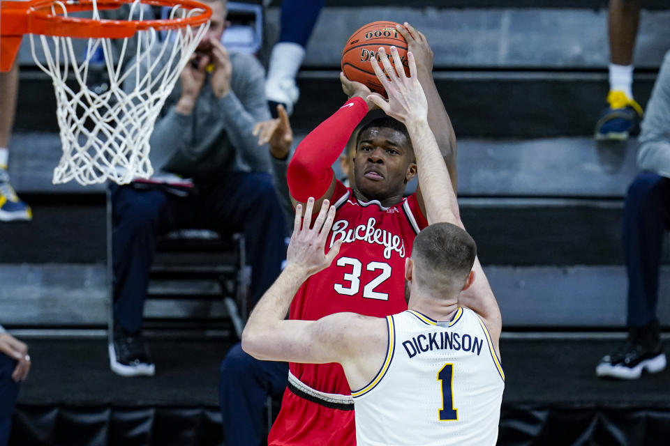 Ohio State forward E.J. Liddell (32) shoots over Michigan center Hunter Dickinson (1) in the first half of an NCAA college basketball game at the Big Ten Conference tournament in Indianapolis, Saturday, March 13, 2021. (AP Photo/Michael Conroy)