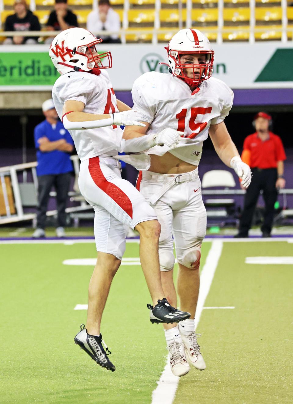 West Hancock seniors Mitchell Smith (15) and Kellen Smith (43) celebrate an interception in the Class A championship on Thursday.