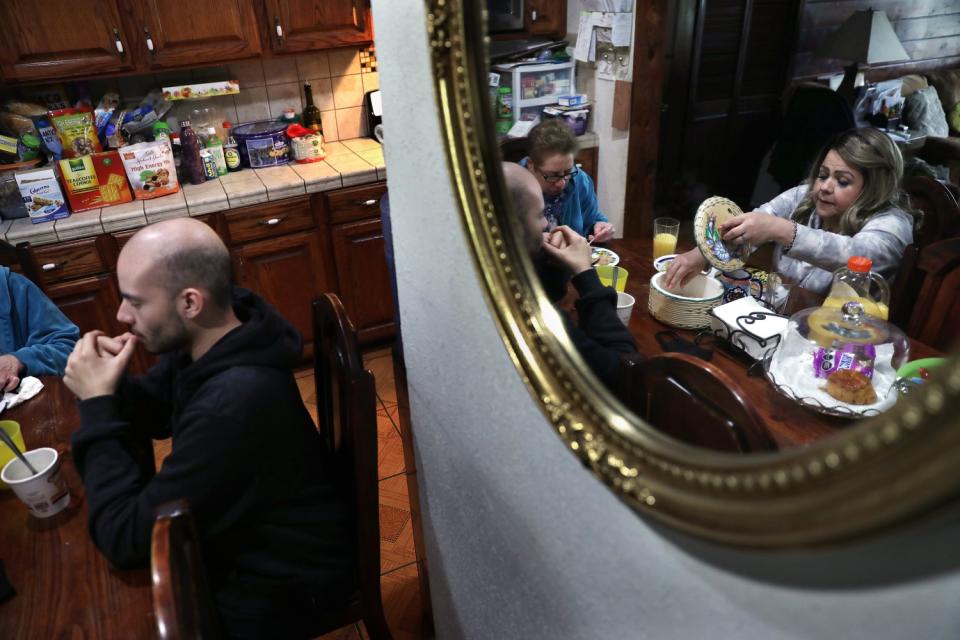 Blanca Lopez, right, eats with her mother Maria Esther Lopez, and son David Muno, left, at home in Glendale.