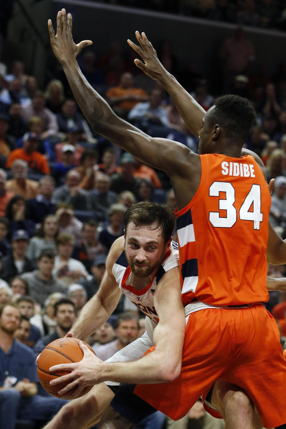 Virginia forward Jay Huff, left, tries to get around Syracuse forward Bourama Sidibe (34) during the second half of an NCAA college basketball game in Charlottesville, Va., Saturday, Jan. 11, 2020. Syracuse defeated Virginia 63-55 in overtime. (AP Photo/Steve Helber)