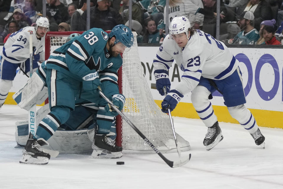 San Jose Sharks defenseman Mario Ferraro (38) defends against a shot by Toronto Maple Leafs left wing Matthew Knies (23) during the second period of an NHL hockey game in San Jose, Calif., Saturday, Jan. 6, 2024. (AP Photo/Jeff Chiu)