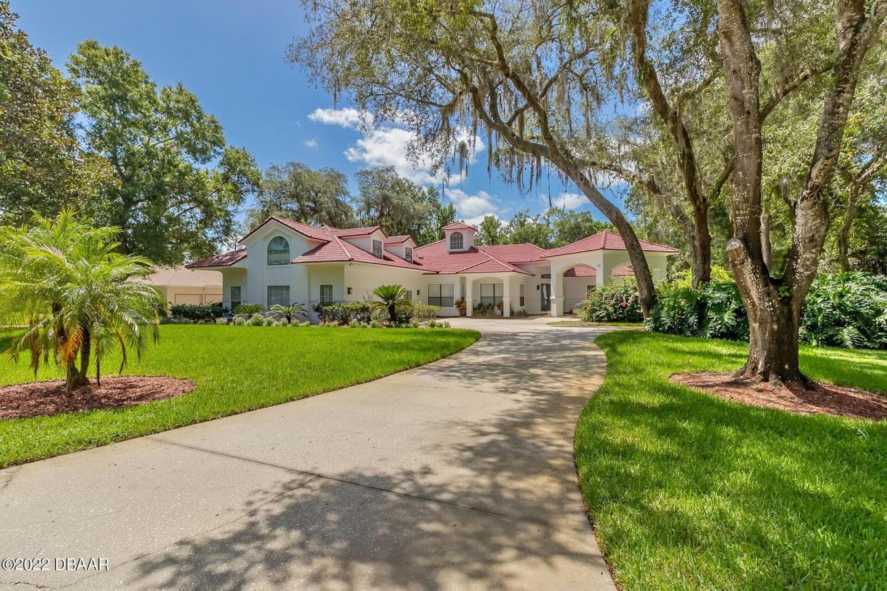 This stunning estate in the gated Ormond Beach community of Moss Point features nearly 5,000 square feet of living space on one-and-a-half acres that back up to the Little Tomoka River.