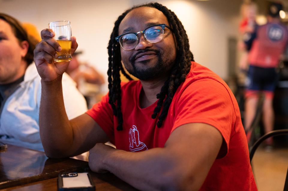 A patron poses with beer inside Ebony & Ivory Brewing, Knoxville's first Black-owned brewery on 2300 North Central Street on Tuesday, Sept. 27, 2022