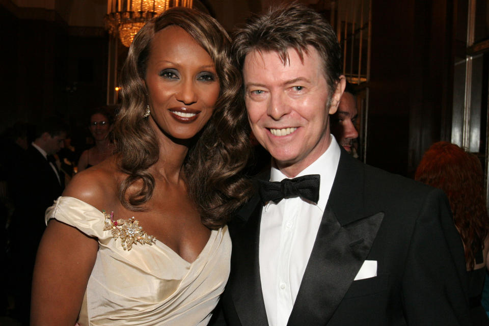 David smiles while posing with Iman