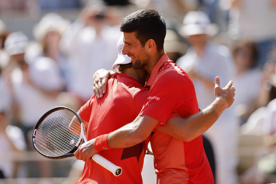 Serbia's Novak Djokovic is congratulated by Aleksandar Kovacevic of the U.S., left, after Djokovic won the first round match of the French Open tennis tournament in three sets, 6-3, 6-2, 7-6 (7), at the Roland Garros stadium in Paris, Monday, May 29, 2023. (AP Photo/Jean-Francois Badias)