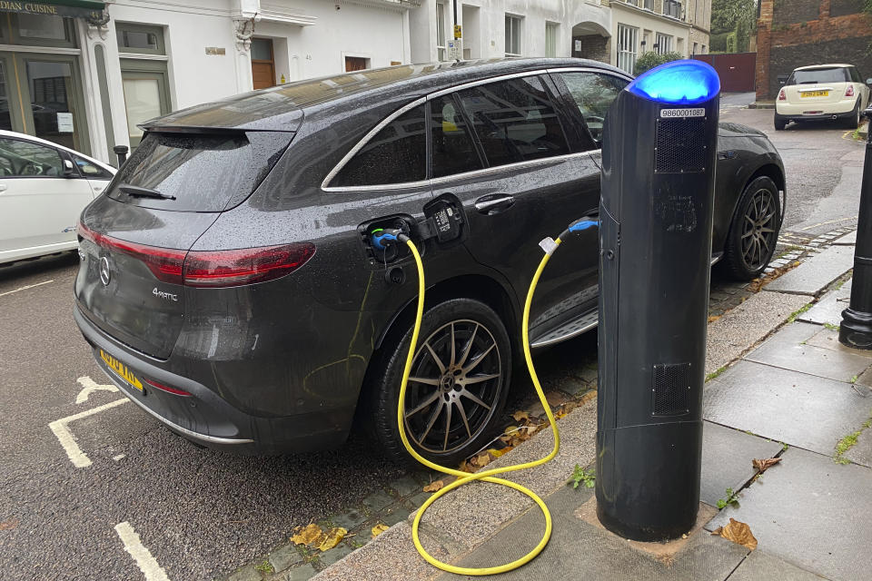 An electric vehicle charges at a public fast-charging station in London on Oct. 20, 2022. London and some other European cities are far ahead of the U.S. when it comes to making fast-charging accessible for renters who can't plug in their EVs at home in a private garage. In the United States, public charging for renters and others without private garages is a barrier to EV adoption. (AP Photo/Courtney Bonnell)