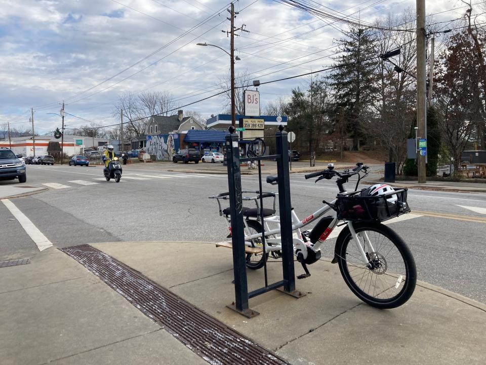 Part of its proposed resurfacing project, the NCDOT invites public input on improvements for Haywood Road. On Dec. 2, 2022, a bike leans against a corral outside of W.A.L.K on Haywood Road.