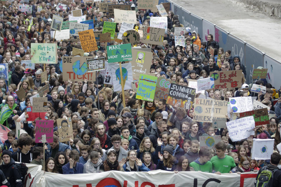 Swedish climate activist Greta Thunberg, center in first row behind the banner, attends the 'Friday For Future' rally in Berlin, Germany, Friday, March 29, 2019. Thousands of students are gathering in the German capital, skipping school to take part in a rally demanding action against climate change. (AP Photo/Markus Schreiber)