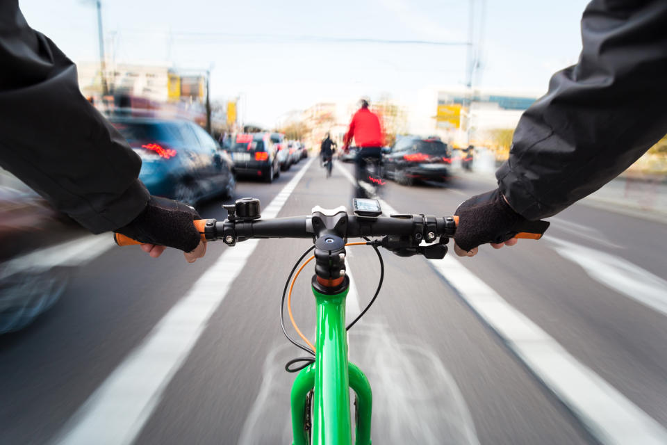 Cyclist drives past cars. Source: Getty Images