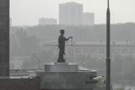 The Lady Justice statue is seen atop of the court building as it rains in Yekaterinburg, Russia, Thursday, July 18, 2024, after a hearing of Wall Street Journal reporter Evan Gershkovich. Gershkovich has attended a hearing behind closed doors in his trial in Russia on espionage charges that he, his employer and the U.S. government vehemently deny. Closing arguments are set for Friday. (AP Photo/Dmitri Lovetsky)