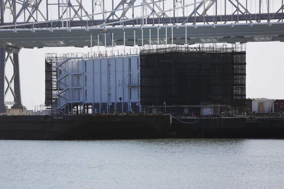 A barge built with four levels of shipping containers is seen at Pier 1 at Treasure Island in San Francisco, California October 28, 2013. How badly does Google want to keep under wraps a mysterious project taking shape on a barge in San Francisco Bay? Badly enough to require U.S. government officials to sign confidentiality agreements. REUTERS/Stephen Lam (UNITED STATES - Tags: SCIENCE TECHNOLOGY BUSINESS)