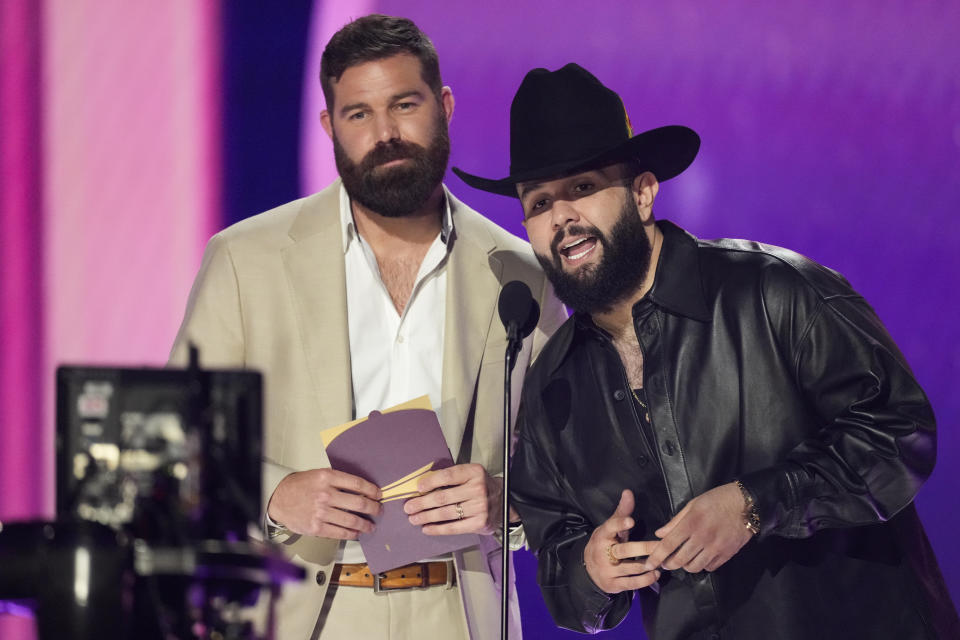 Jordan Davis, left, and Carin Leon present the award for male artist of the year during the 59th annual Academy of Country Music Awards on Thursday, May 16, 2024, at the Ford Center in Frisco, Texas. (AP Photo/Chris Pizzello)