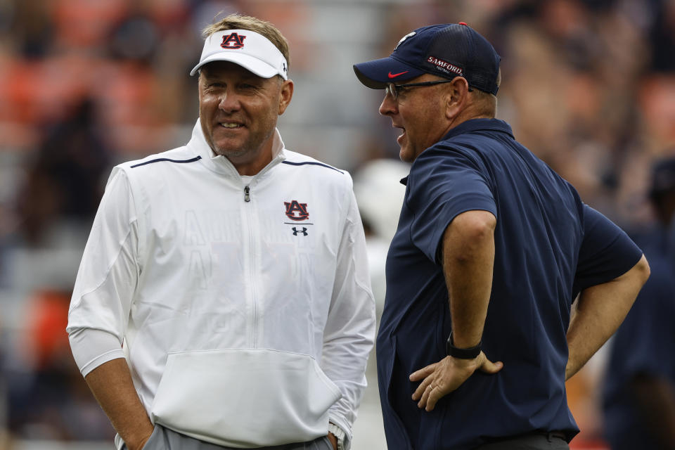 Auburn head coach Hugh Freeze, left, and Samford head coach Chris Hatcher, right, talk before an NCAA college football game Saturday, Sept. 16, 2023, in Auburn, Ala. (AP Photo/Butch Dill)