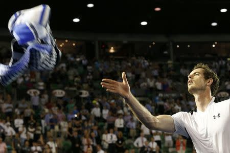 Britain's Andy Murray throws his towel to supporters after winning his quarter-final match against Spain's David Ferrer at the Australian Open tennis tournament at Melbourne Park, Australia, January 27, 2016. REUTERS/Tyrone Siu