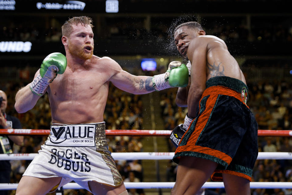 Canelo Alvarez, left, of Mexico, hits Daniel Jacobs during a middleweight title boxing match Saturday, May 4, 2019, in Las Vegas. (AP Photo/John Locher)