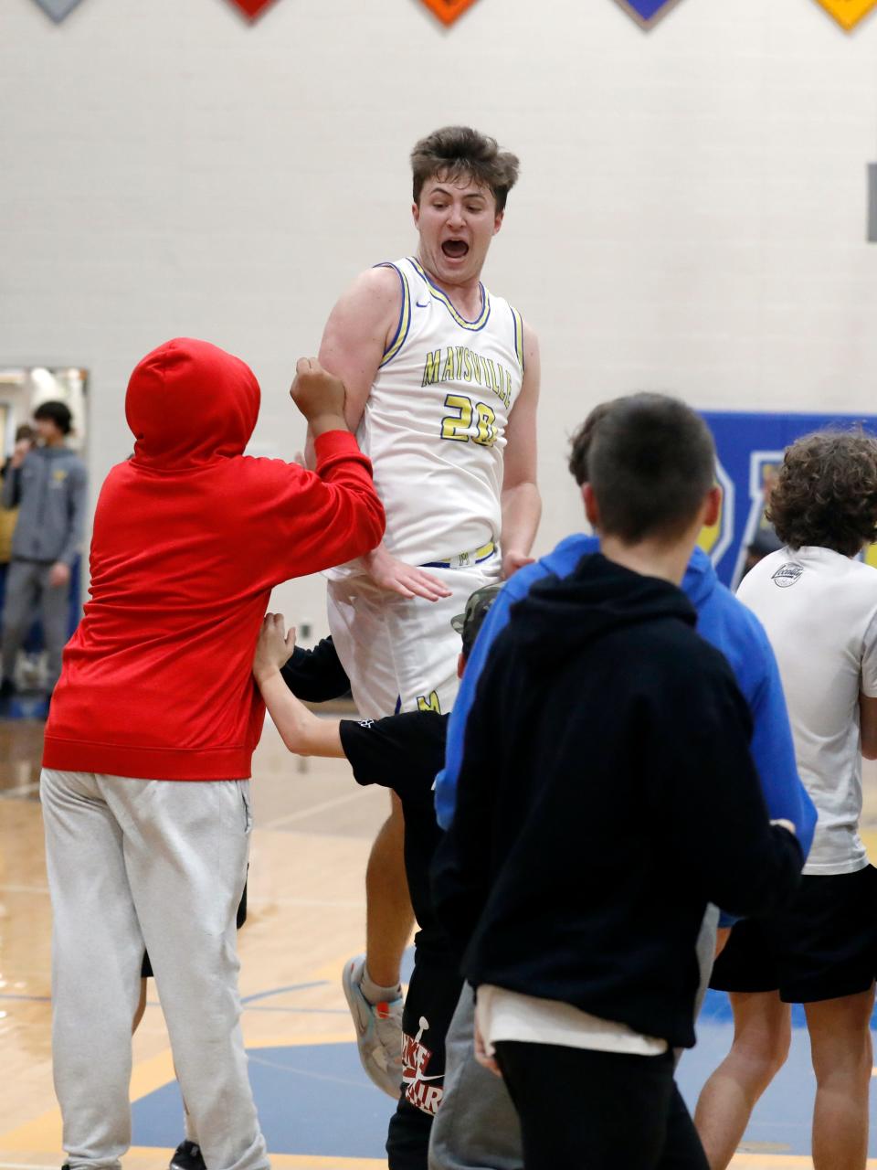 Maysville senior Connor Larimer celebrates with the fans following a 57-46 win against visiting Tri-Valley on Friday night in Newton Township. Larimer's interior defense and rebounding played critical roles in the undefeated Panthers' taking command in the Muskingum Valley League's Big School Division.