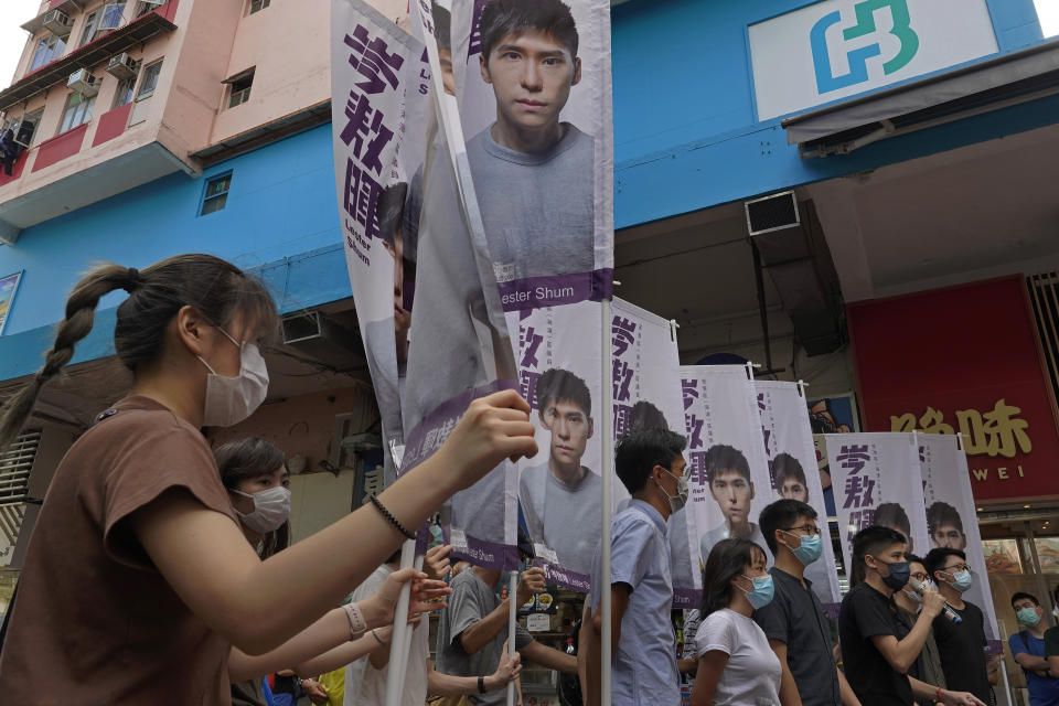 Hong Kong activist Joshua Wong, fourth from right, attends an activity for the upcoming Legislative Council elections in Hong Kong Saturday, June 20, 2020. Wong said Thursday that opposing a draft national security law for Hong Kong “could be my last testimony (while) I am still free.” (AP Photo/Vincent Yu)
