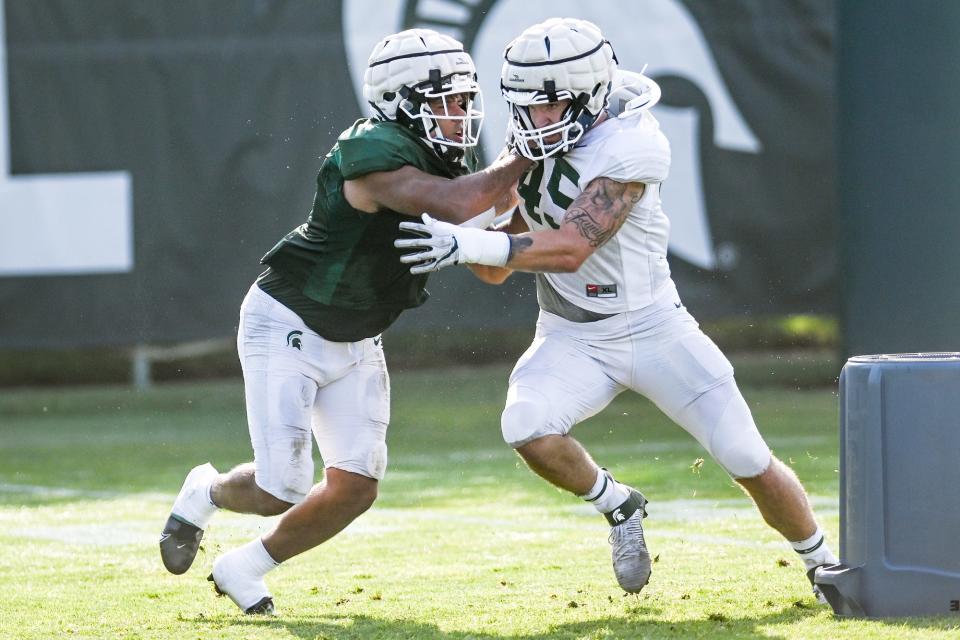 Michigan State's Noah Harvey, right, tires to get past Connor Heyward during football camp on Tuesday, Aug. 17, 2021, on the MSU campus in East Lansing.