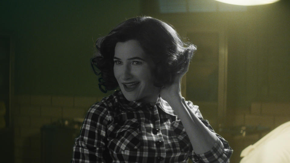 Kathryn Hahn in black and white against a colour background as Agatha Harkness