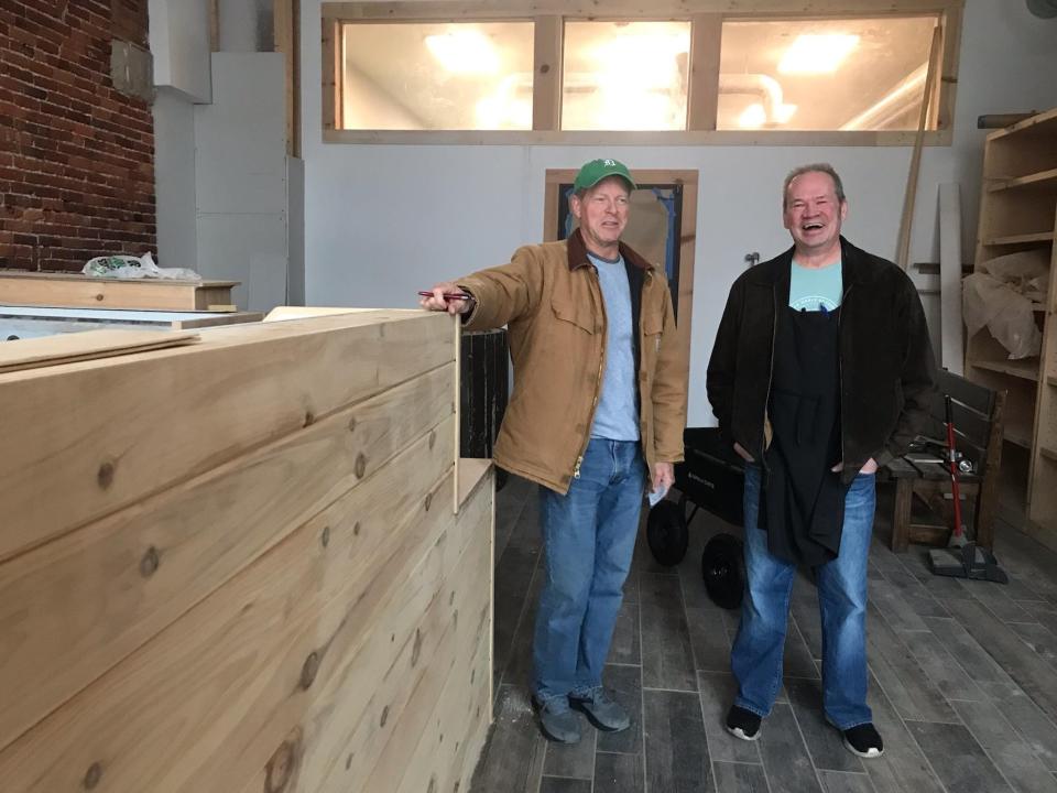 Jeff Payton, who owns the Vintage Tavern, and long-time friend Craig Becker, right, chitchat inside the storefront for 206 Huron Ave., where they plan to open Root Juicery, on Wednesday, Dec. 8, 2021. Though some renovations have begun, the two had no set timeline to open.