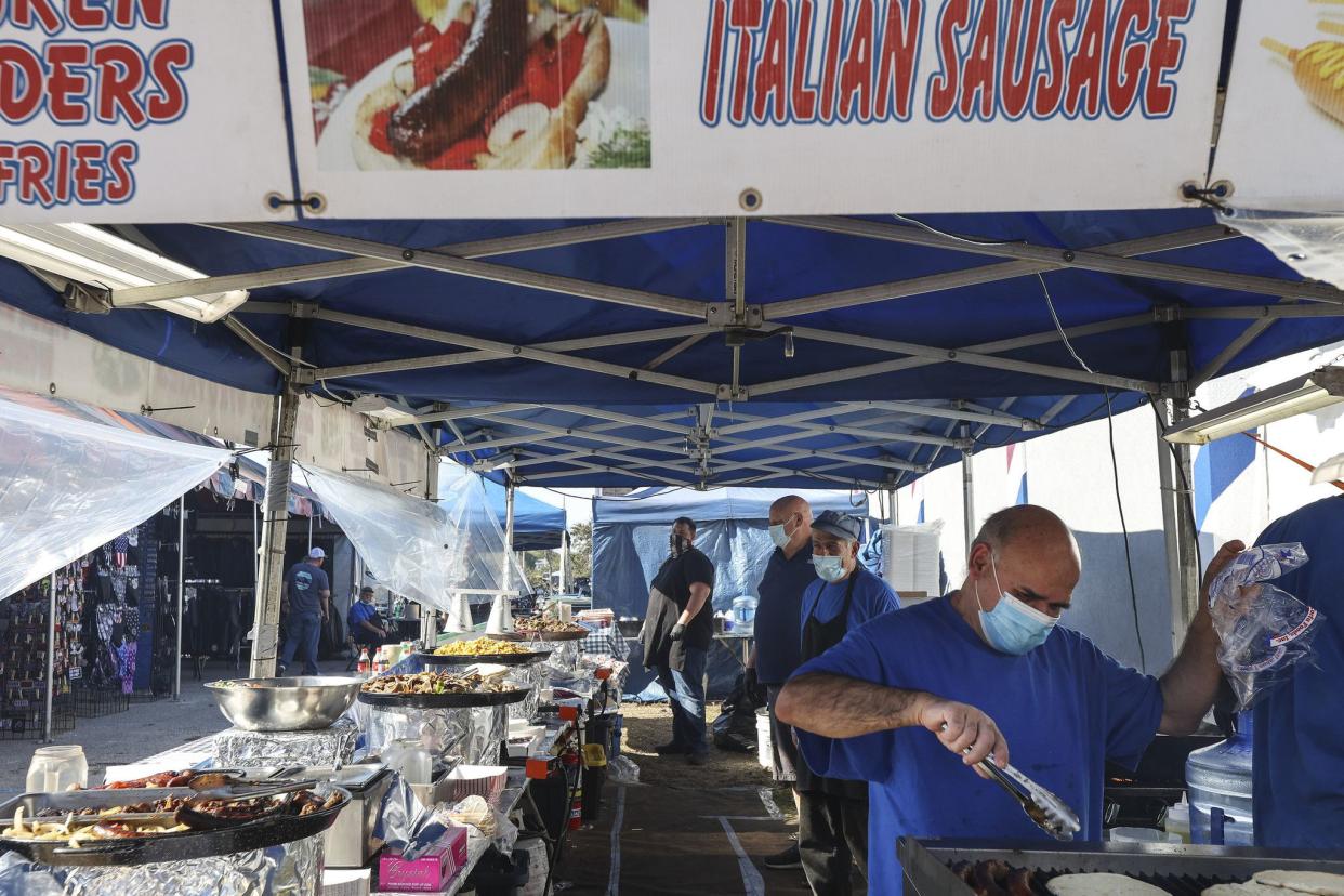 Vendors prepare and sell food along Main Street in Daytona, FL during Bike Week on Friday, March 5, 2021. (Sam Thomas/Orlando Sentinel)