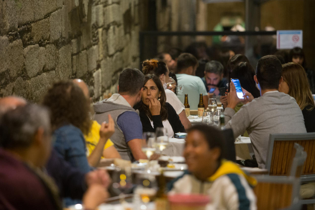 A group of people on a terrace during the night on the same day that the Ministry of Health has decreed the closure of nightlife, as well as the obligation to close the restaurant premises at 1 am and the separation of meter and a half between diners, on August 14, 2020 in Lugo, Galicia, Spain. (Carlos Castro/Europa Press via Getty Images)