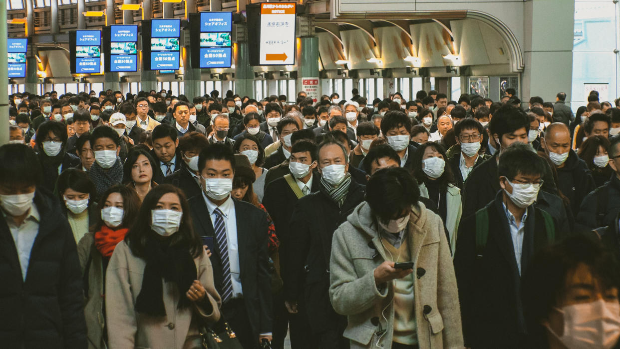 TOKYO, JAPAN - MARCH 2020 : Crowd of people walking at Shinagawa station in busy morning rush hour.