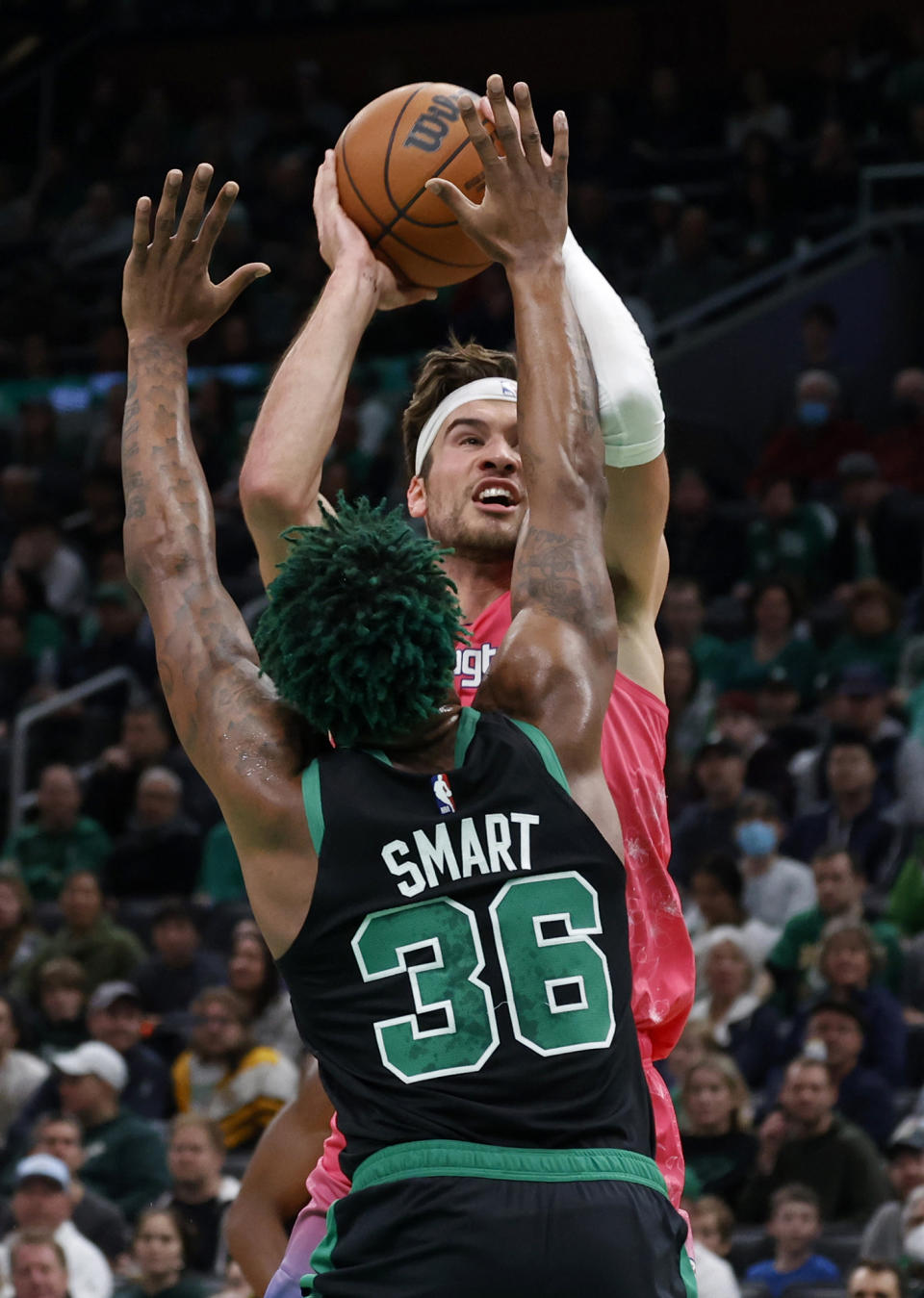 Washington Wizards forward Corey Kispert (24) shoots over Boston Celtics guard Marcus Smart (36) during the first half of an NBA basketball game Sunday, Nov. 27, 2022, in Boston. (AP Photo/Mary Schwalm)