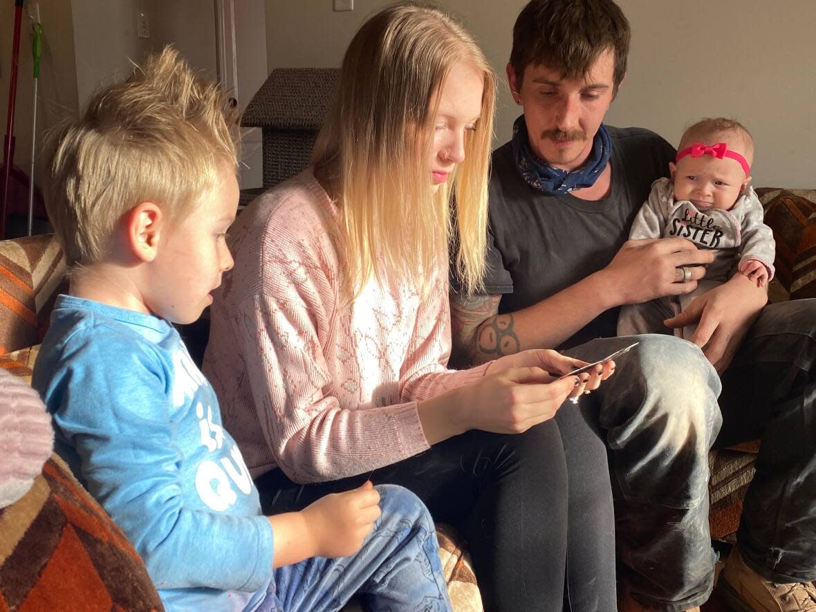 Meaghan Law, her partner Keith Reid, and their two children, Bryce, four, and Melody, five months old, were shocked by what they found when they returned to their home in Napadogan, N.B.  (Wayne Thibodeau/CBC - image credit)