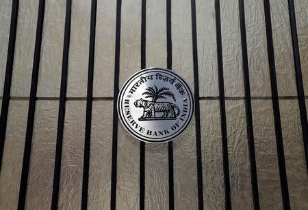 FILE PHOTO: A Reserve Bank of India (RBI) logo is seen at the entrance gate of tts headquarters in Mumbai, India June 7, 2017. REUTERS/Shailesh Andrade/File Photo