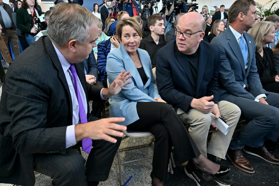 JetBlue Airways CEO Robin Hayes talks with Gov. Maura Healey and Congressman Jim McGovern after announcing new JetBlue service at Worcester Regional Airport.