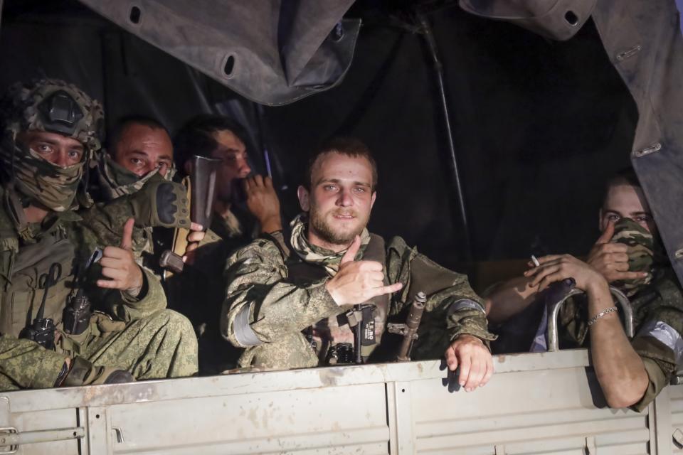 FILE - Members of the Wagner Group military company sit in their vehicle on a street in Rostov-on-Don, Russia, Saturday, June 24, 2023, as they prepare to leave an area at the headquarters of the Southern Military District. A week after the mutiny raised the most daunting challenge to President Vladimir Putin’s rule in over two decades, key details about the uprising remain shrouded in mystery. (AP Photo, File)