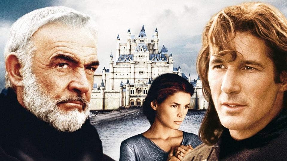 Sean Connery, Richard Gere, and Julia Ormond as Arthur, Lancelot, and Guinevere, respectively, positioned in front of Camelot in a promo image for Arthurian movie First Knight.