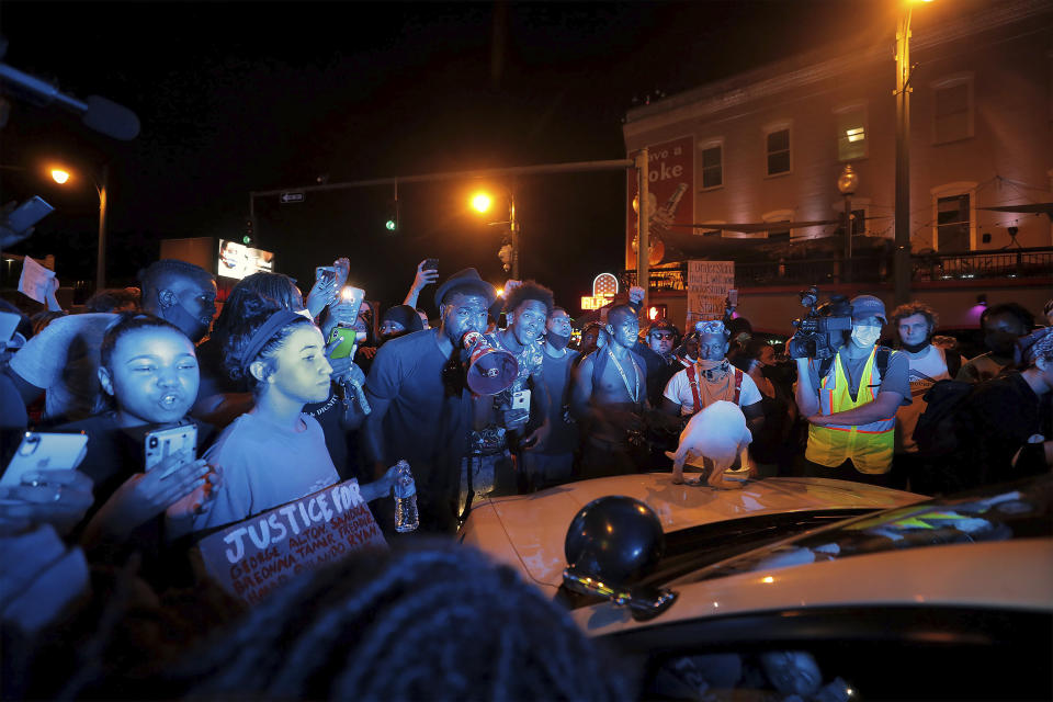 Protestors confront a police officer in his car in Memphis, Tennessee during a protest over the death of George Floyd May 31, 2020. (Patrick Lantrip/Daily Memphian via AP)