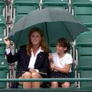 <p>A young Princess Eugenie, safely under an umbrella with her mother, seems undeterred by the bad weather. <br></p>