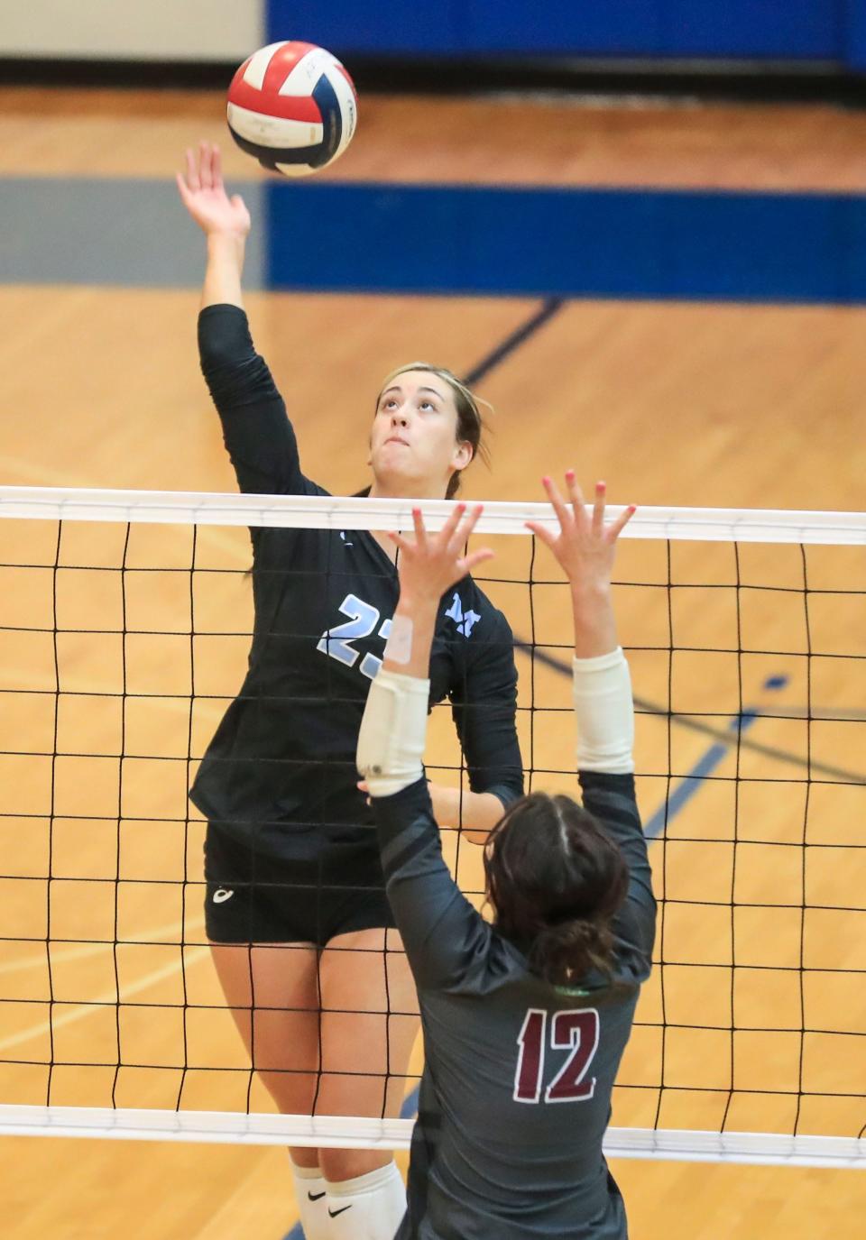 Mercy's Mary Schneidtmiller hits the ball over Holy Cross's Rivers McDonald during the Sixth Region final at Valley High School Wednesday night. The Jaguars would take all three sets over the Cougars to win the 2021 Sixth Region title. Oct. 27, 2021