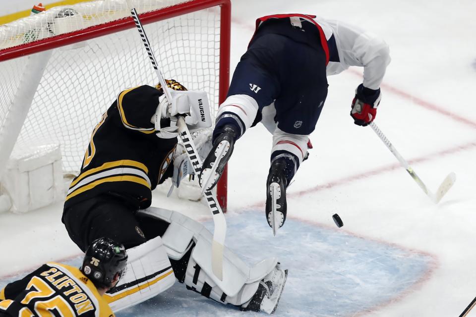 Washington Capitals' Anthony Mantha, right, collides with Boston Bruins goalie Tuukka Rask during the third period in Game 4 of an NHL hockey Stanley Cup first-round playoff series Friday, May 21, 2021, in Boston. (AP Photo/Michael Dwyer)